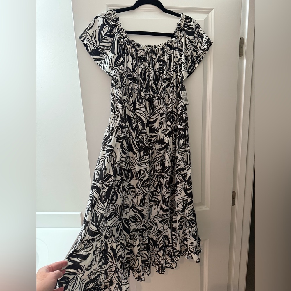 Black and white dress with ruffle on the bottom and tie around waist. Size XXL